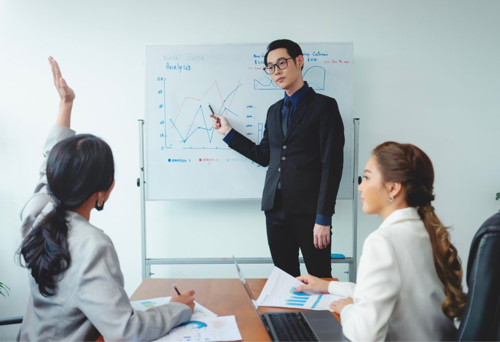 asian-businessman-presenting-his-work-corporate-colleagues-meeting-office 1